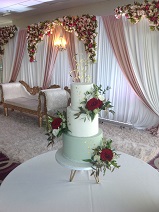 Sage green wedding cake with gold leaf